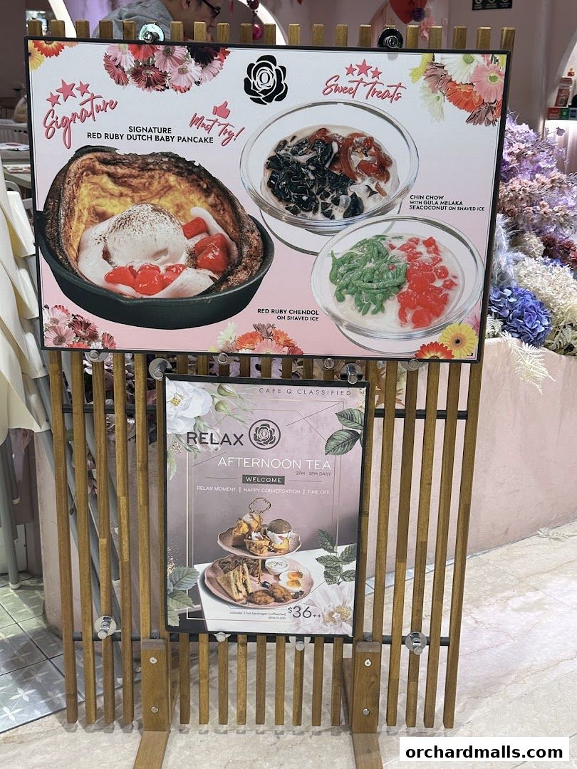 A display board showcasing signature dishes and afternoon tea at Cafe Q Classified.