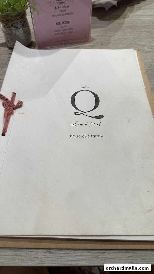 A menu from Café Q Classified featuring drinks like Korean Soju and sake.
