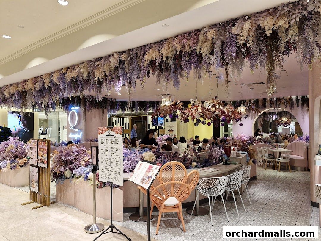 A beautifully decorated cafe with floral arrangements and soft lighting, offering a cozy dining experience.