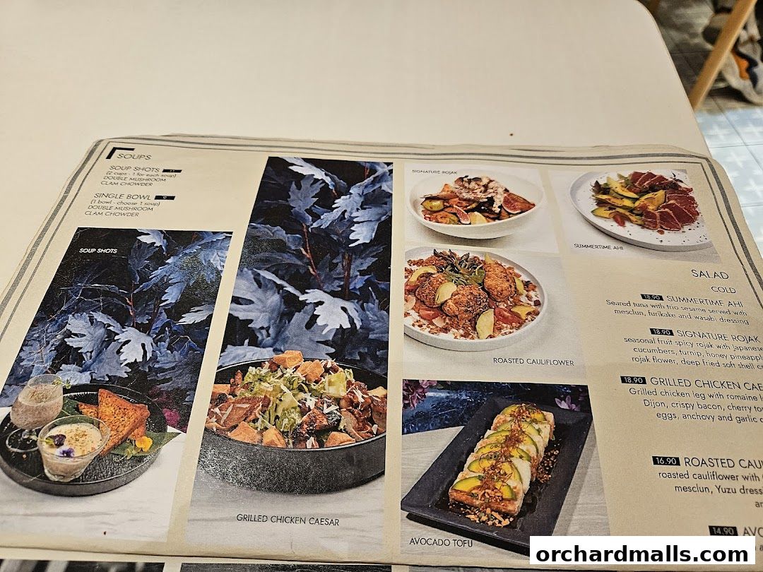 A menu from café Q classified featuring soups, salads, and other dishes with appealing food photography.