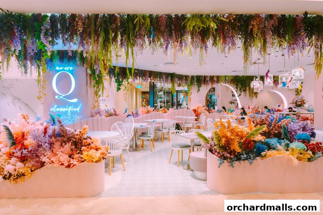A beautifully decorated cafe interior with floral arrangements and neon signage.