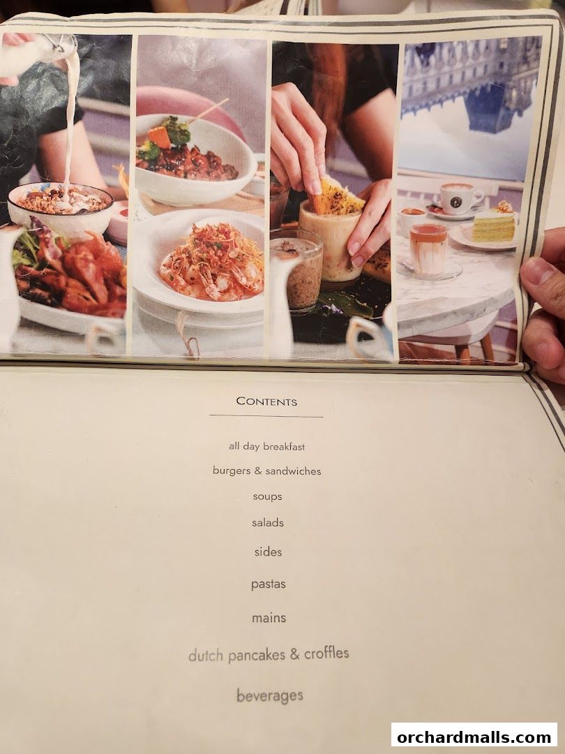 A menu page from cafe Q classified with food images and a table of contents.