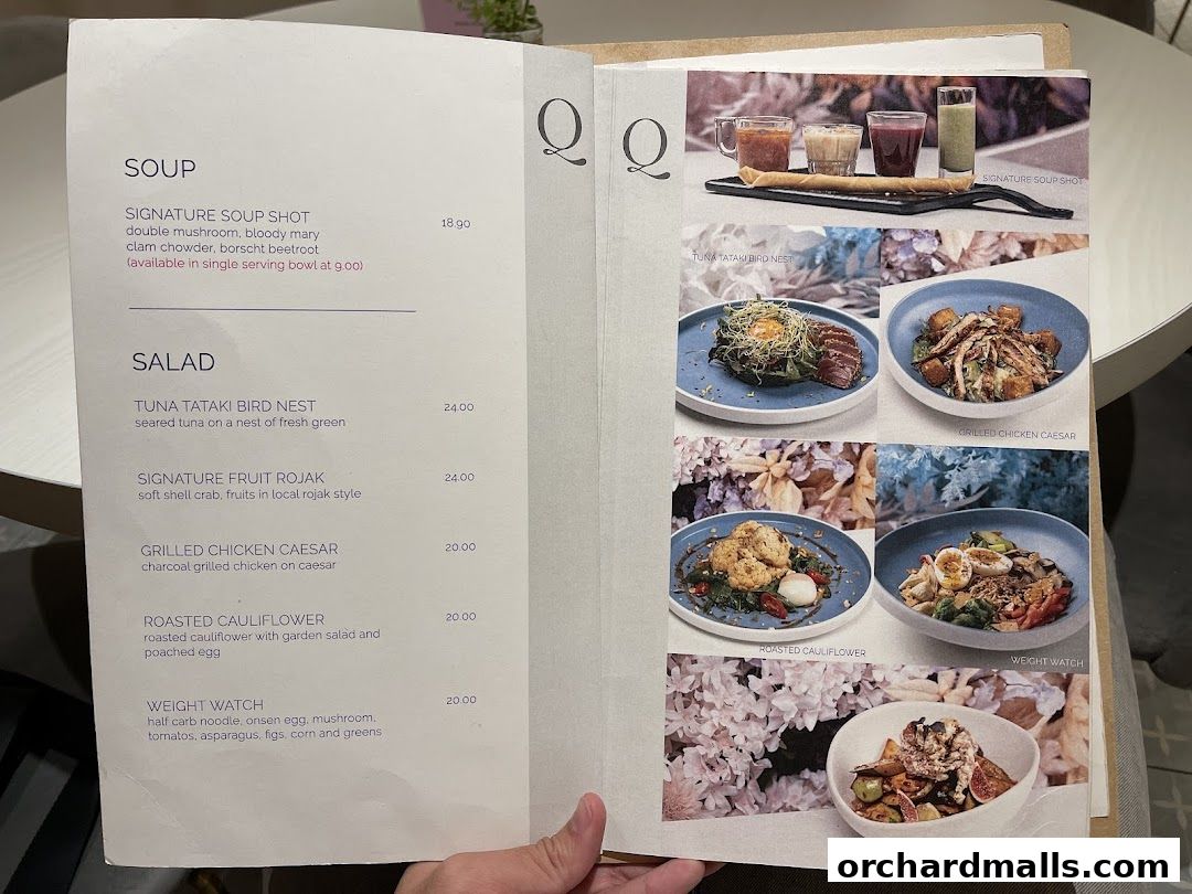A menu from cafe Q classified featuring soups and salads with appealing food photography.