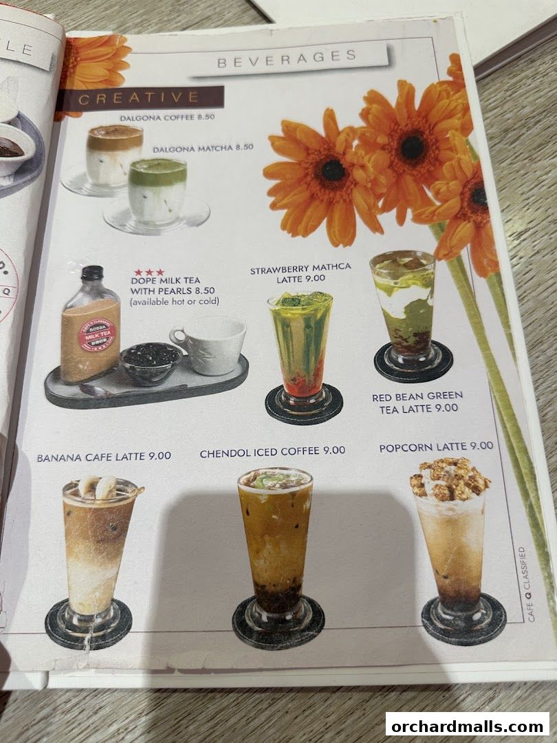 A menu page from Cafe Q Classified showcasing various creative beverage options.