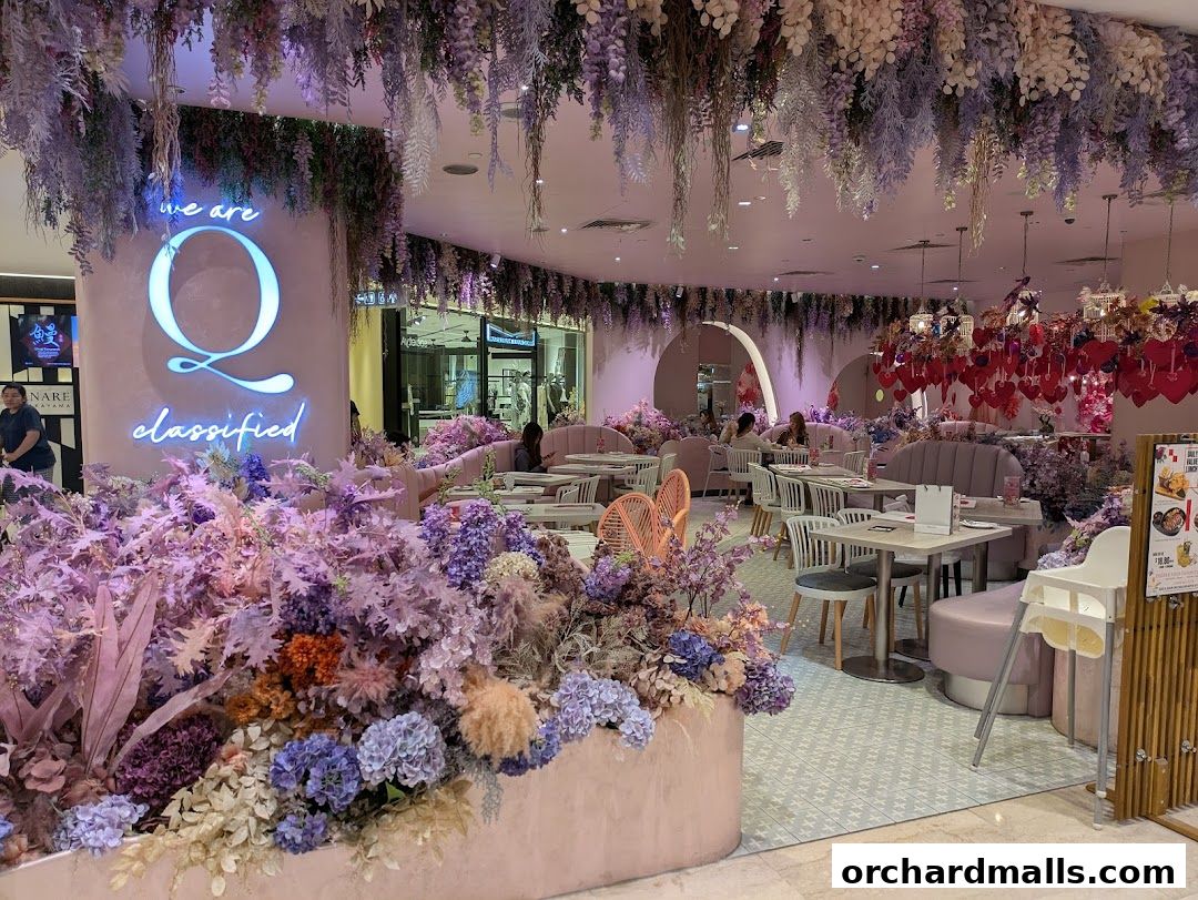 A beautifully decorated cafe with abundant floral arrangements and soft lighting.