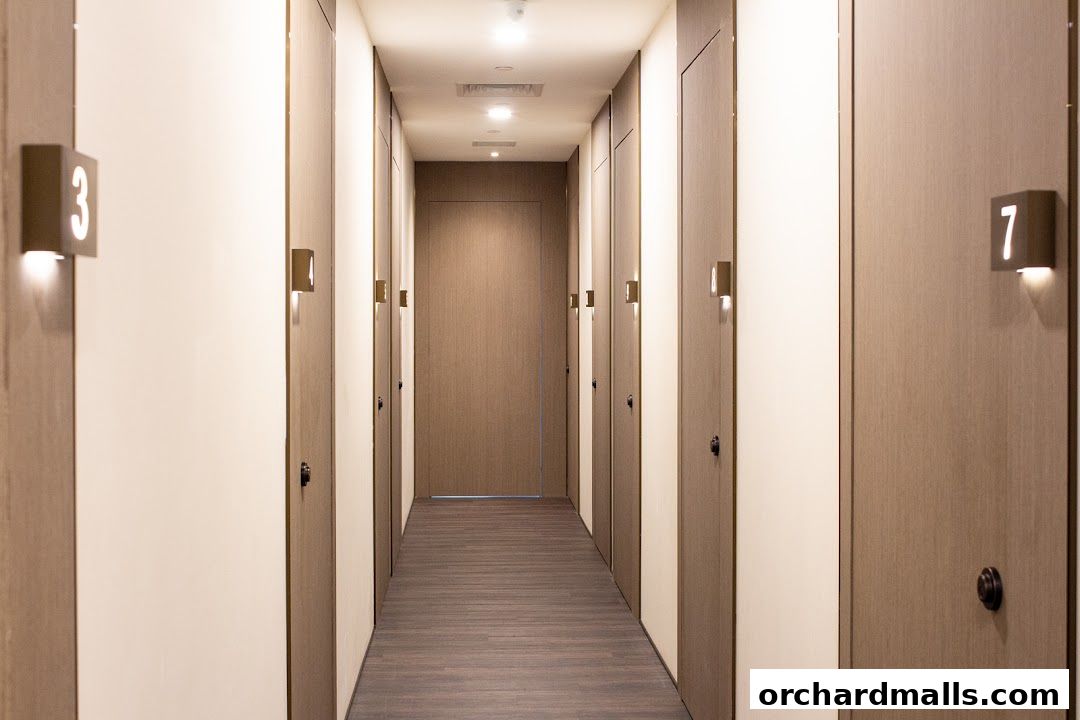 A clean, modern hallway with numbered doors and soft lighting.