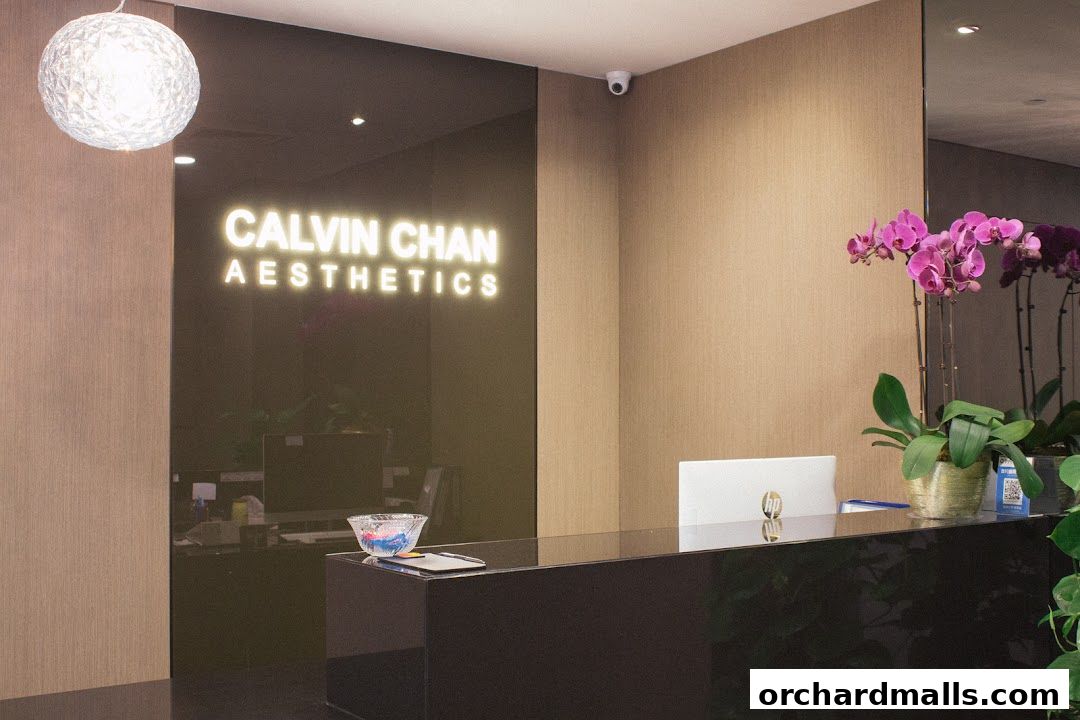 The reception area of Calvin Chan Aesthetics Laser Clinic with a modern desk and glowing logo.