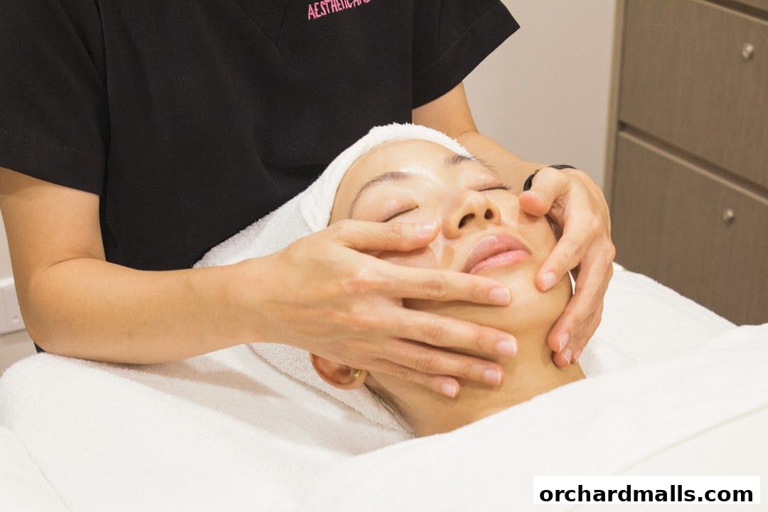 Aesthetician performing a facial massage on a client at Calvin Chan Aesthetic Laser Clinic.
