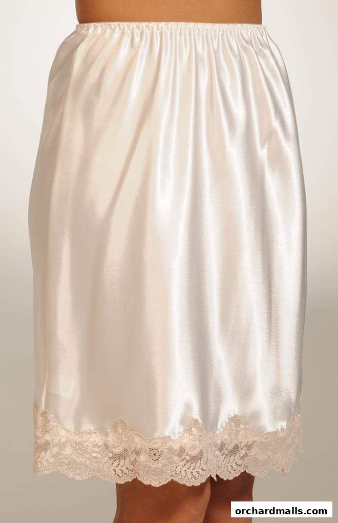 A close-up of a white satin slip with lace trim at the hem.