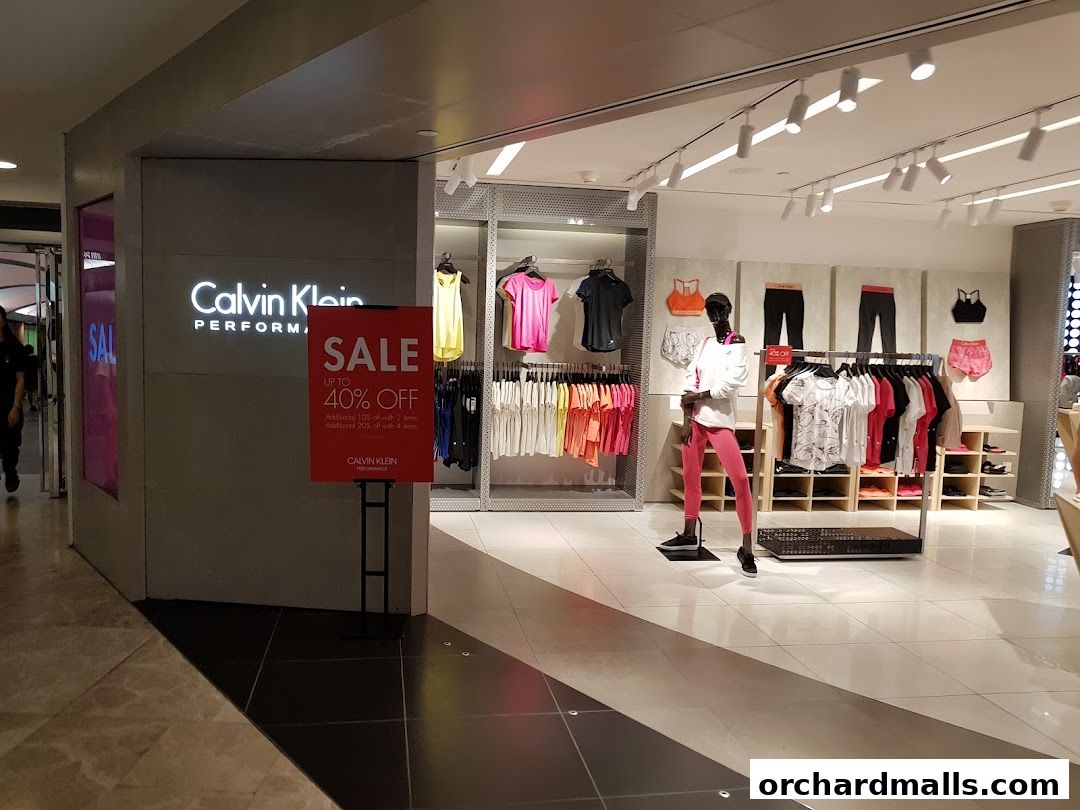 Calvin Klein Performance store entrance with a sale sign and displayed apparel.