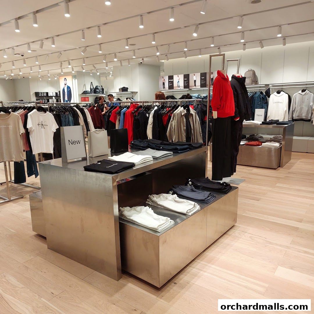 Interior view of a Calvin Klein store showcasing a variety of apparel on display racks and shelves.