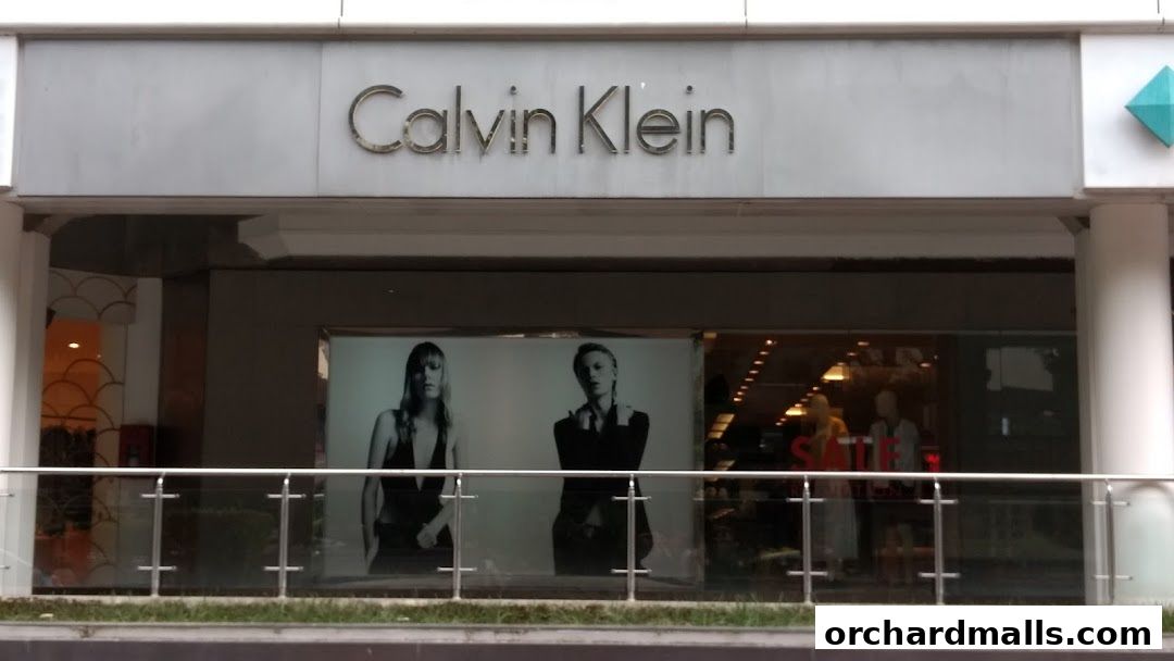 The Calvin Klein store front features its iconic logo and a window display with models.