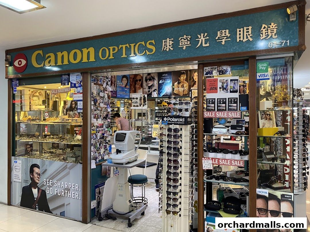 Exterior of Canon Optics, an eyewear store, showcasing various glasses and promotional materials.