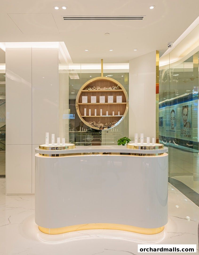 A clean and modern reception area with skincare products displayed on shelves and counter.