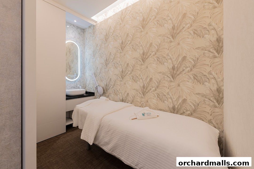 A clean and serene treatment room with a massage bed and a vanity area.