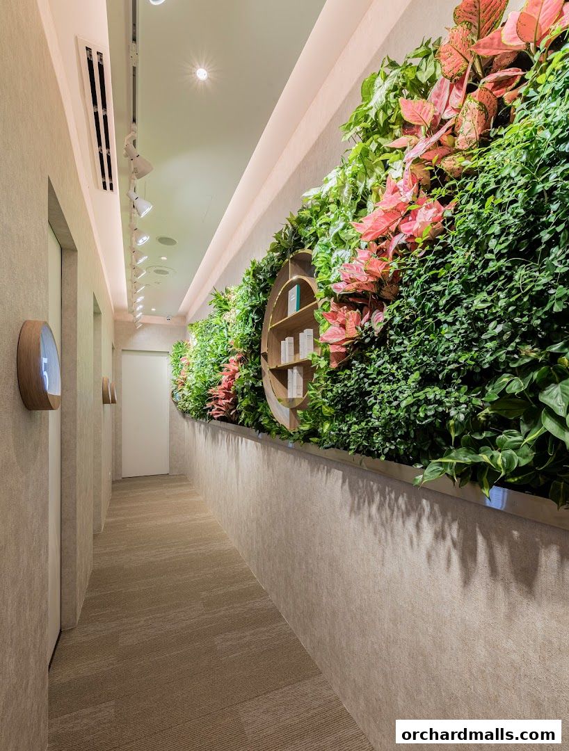 A serene hallway with a lush vertical garden and product display.