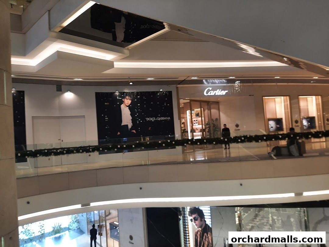 The Cartier store entrance at ION Orchard, with a large advertisement on the left.