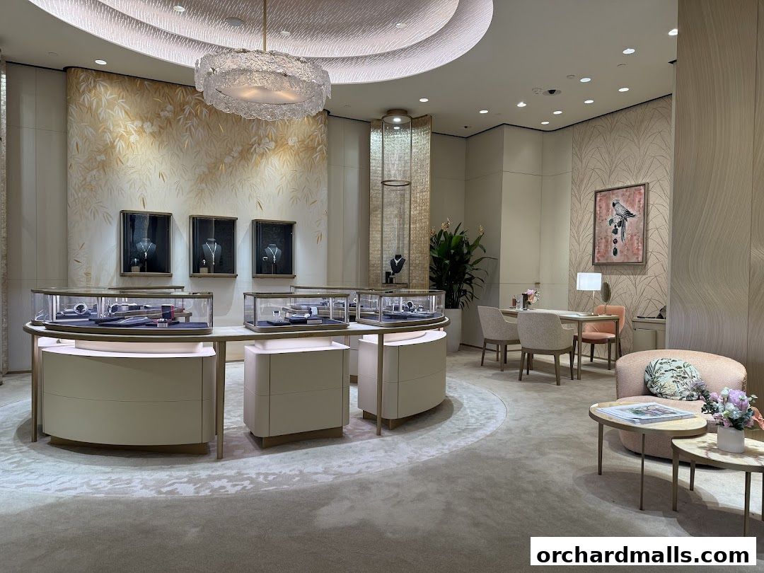 Interior of a luxurious jewelry store with display cases and seating areas.