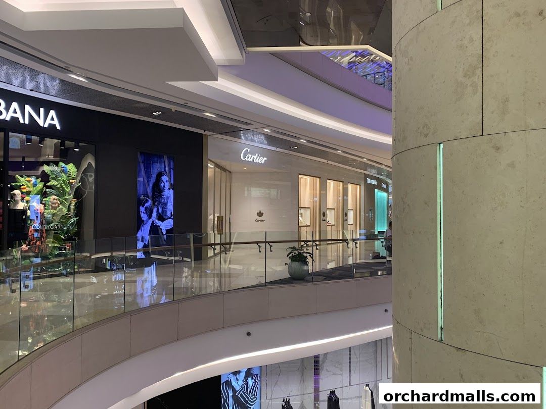 Interior view of a shopping mall with the Cartier store visible.