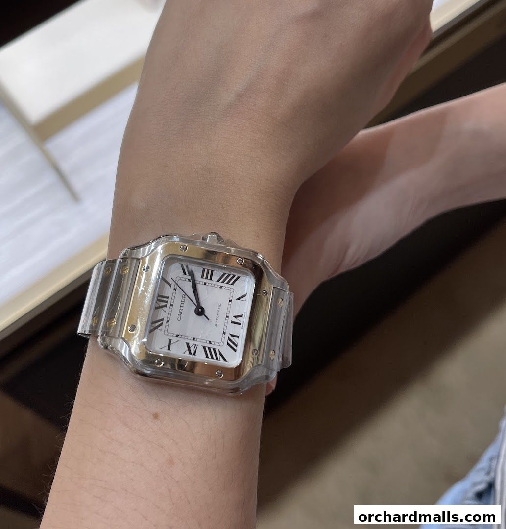 A close-up of a Cartier watch on a person's wrist, showcasing its design.