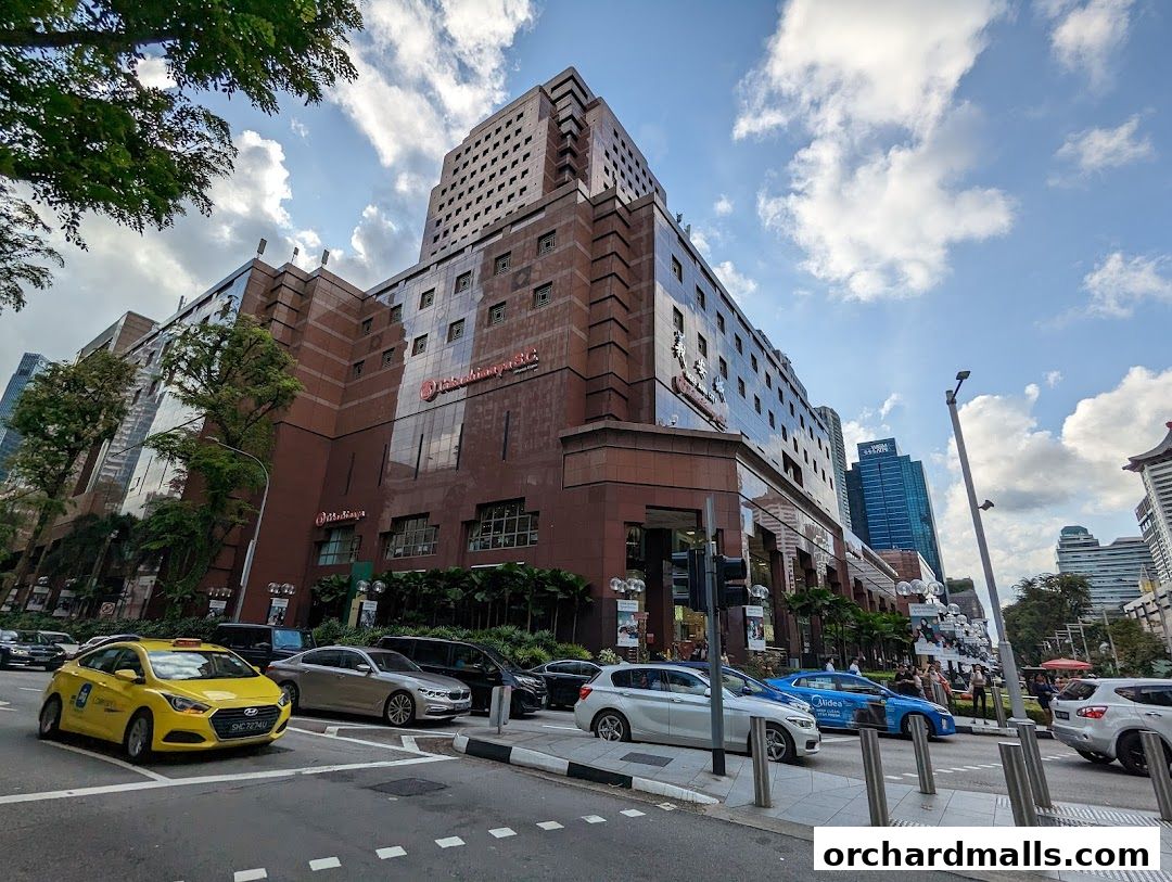 Exterior view of the Cartier Ngee Ann City store with a street and traffic in the foreground.