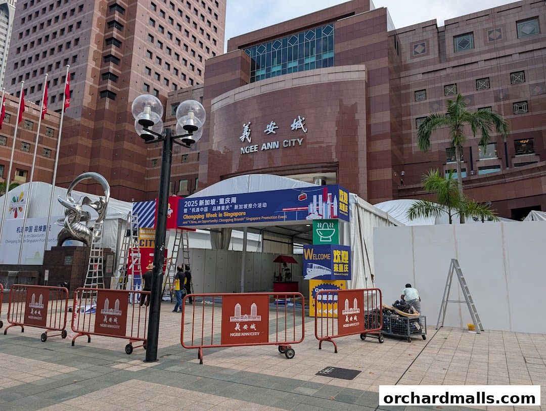 Ngee Ann City building exterior with event tents and promotional banners.
