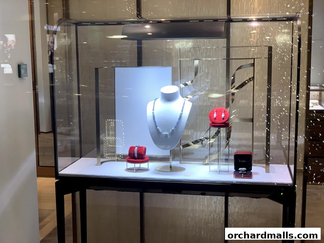Cartier Ngee Ann City display window featuring a necklace, earrings, and rings.