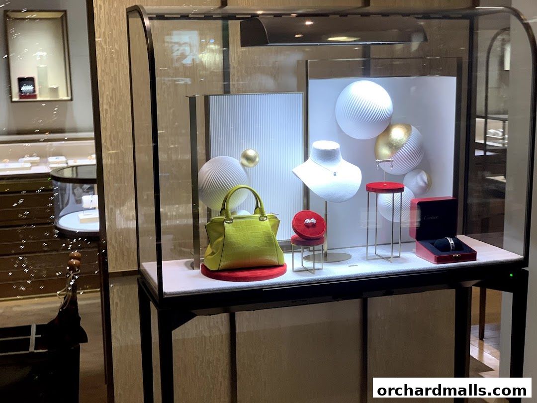 Cartier Ngee Ann City display window featuring jewelry, a handbag, and decorative elements.