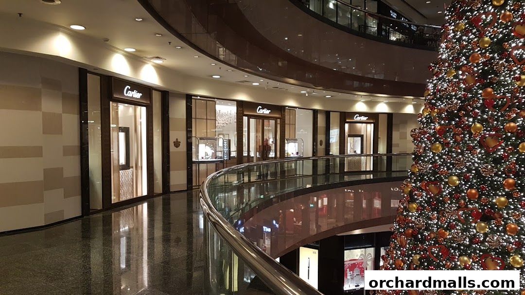 Cartier store front in a mall with a large decorated Christmas tree.