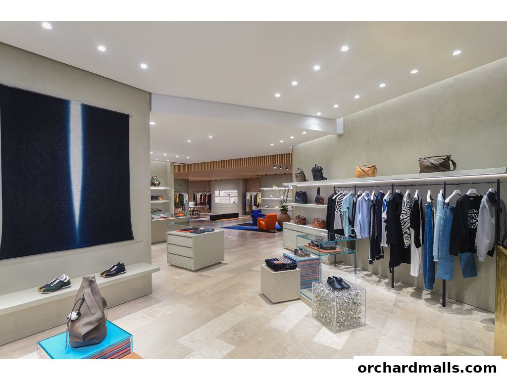 Interior view of a modern fashion boutique showcasing apparel, handbags, and footwear.
