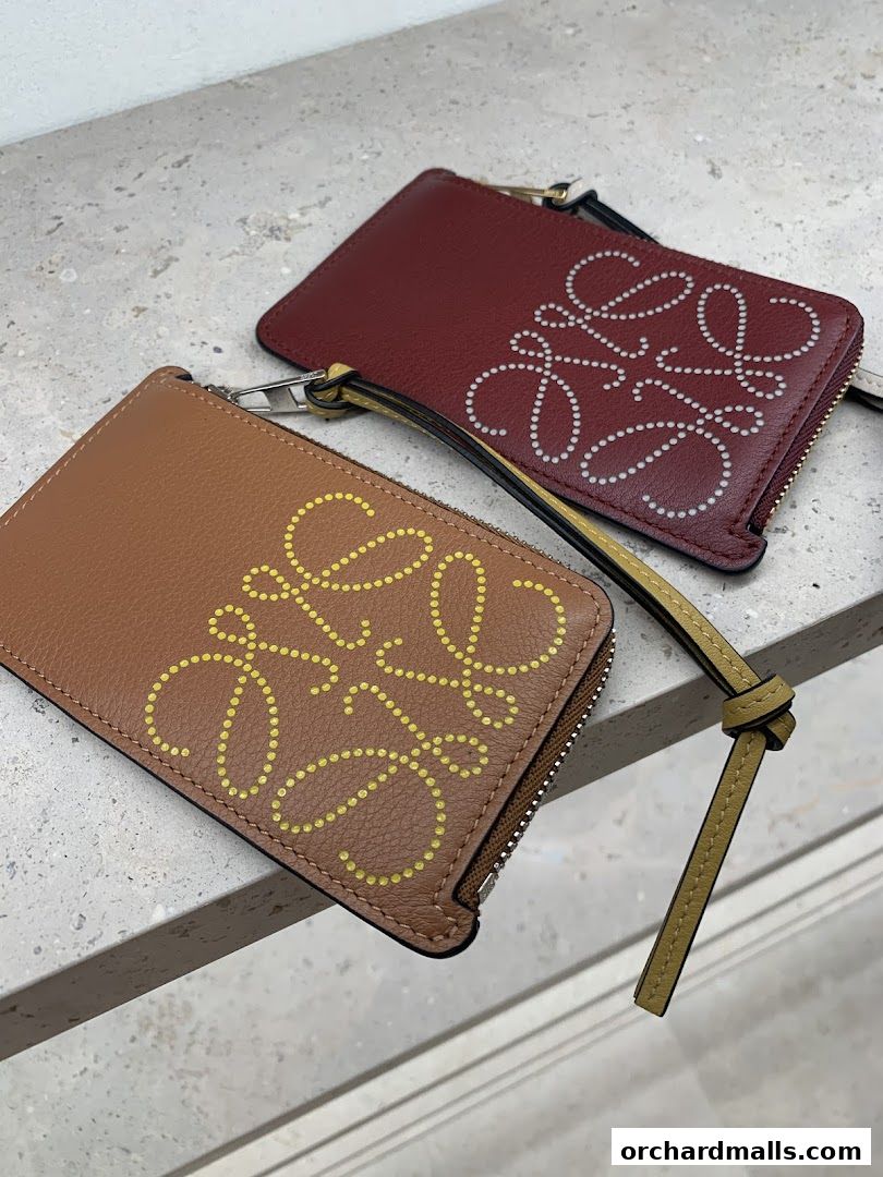 Two leather cardholders with the Loewe anagram logo in different colors.