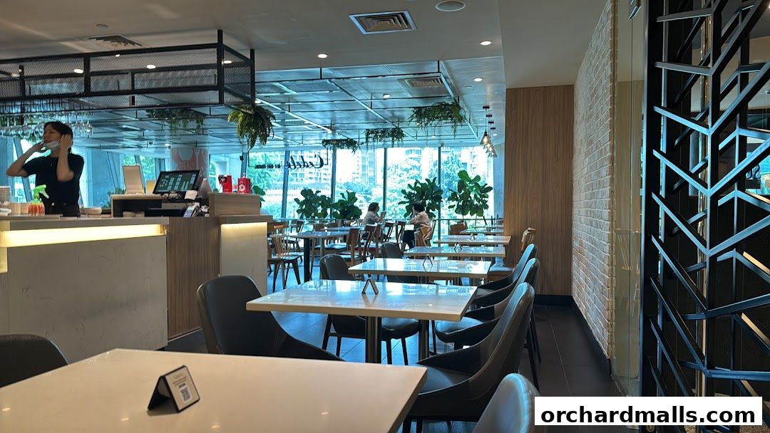 Interior view of Cedele All Day Dining with tables, chairs, and a counter.