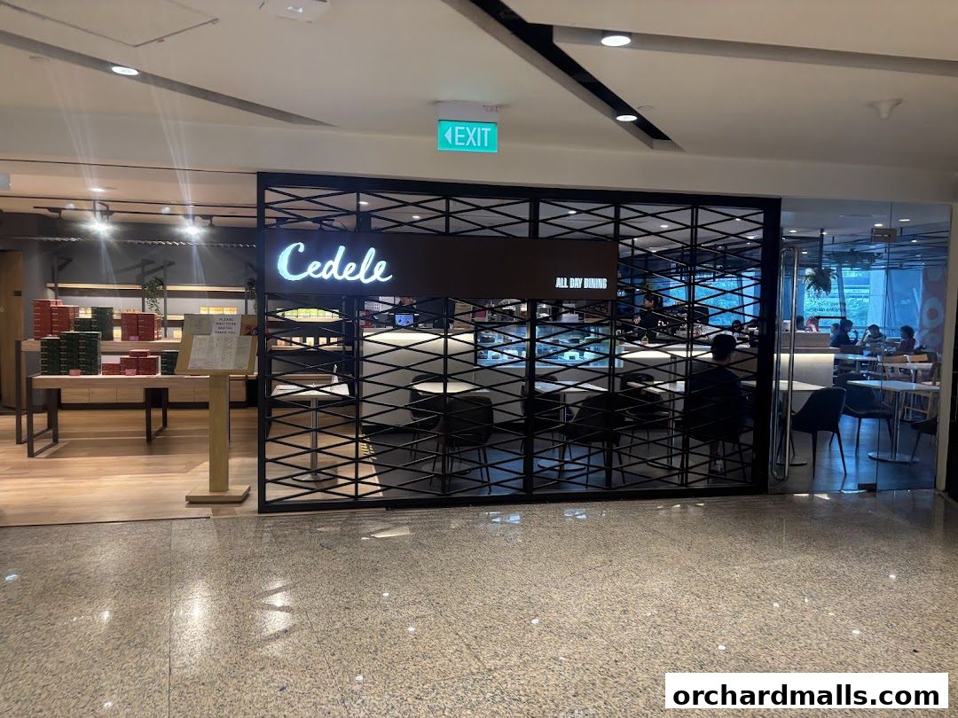 The entrance of Cedele All Day Dining with a display of boxed goods and seating area.