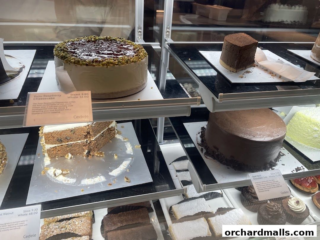 A display case filled with various cakes and pastries from Cedele.