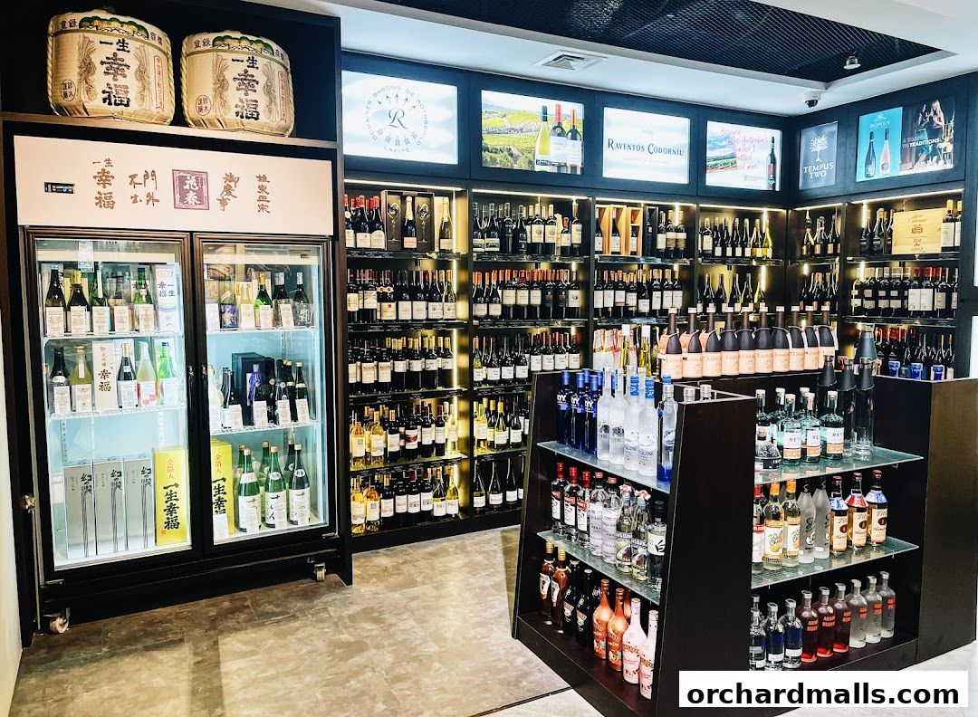 A well-stocked liquor and wine store with shelves full of bottles and a refrigerated display.