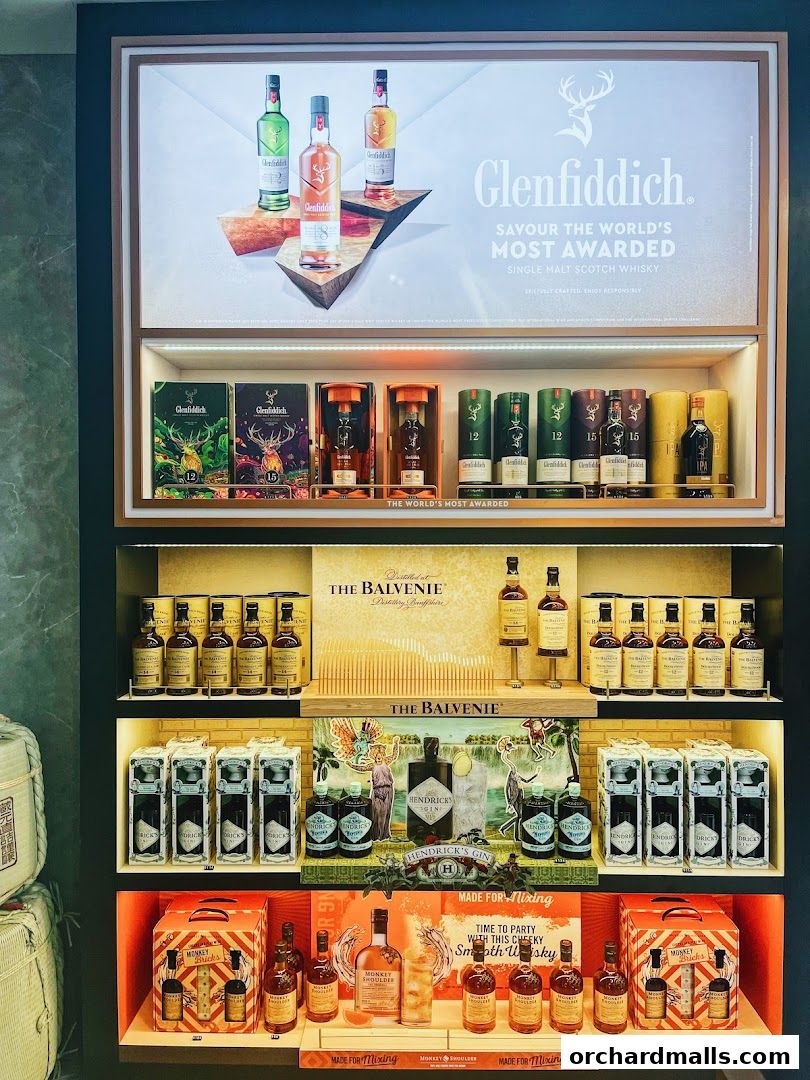 A display of premium whiskies and gins, featuring Glenfiddich, The Balvenie, and Hendrick's.