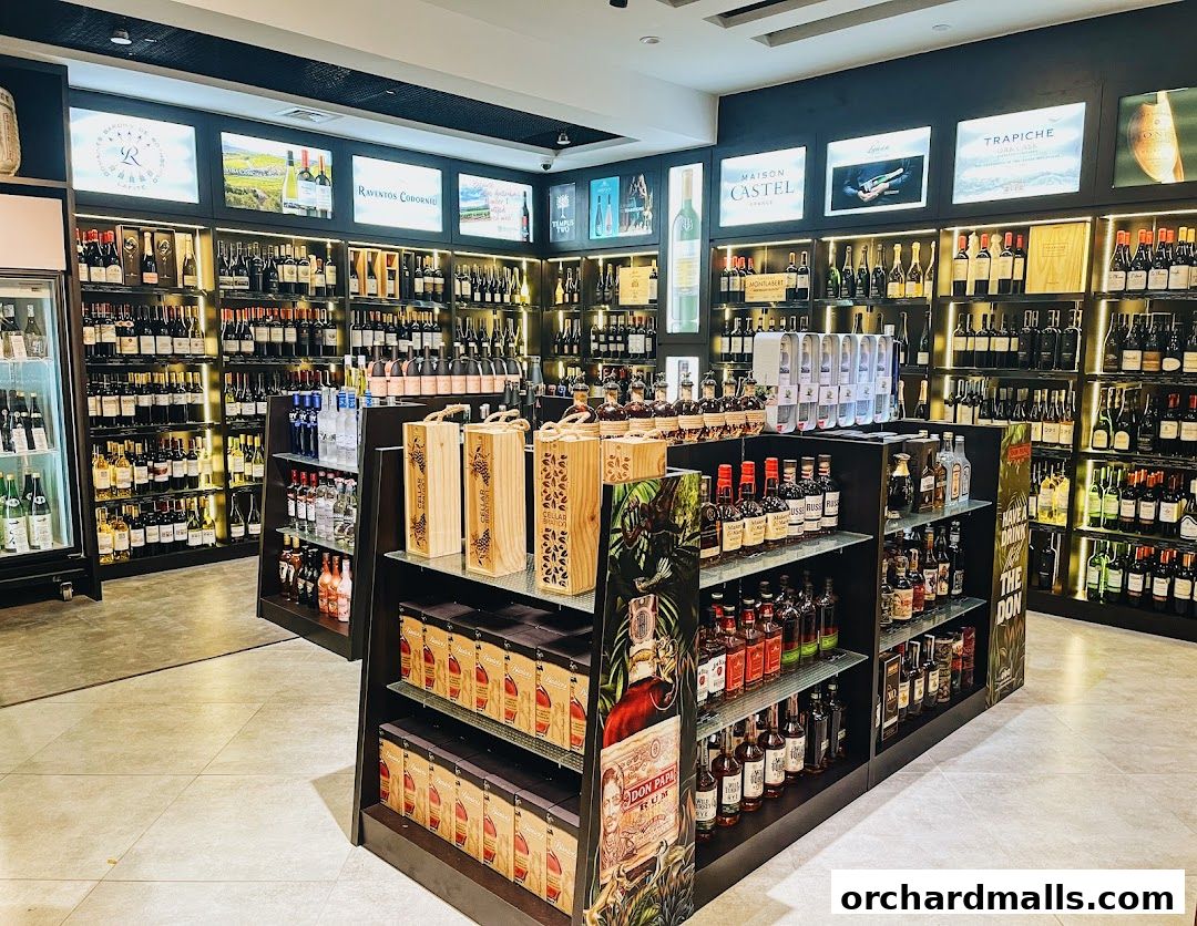 Interior view of a well-stocked liquor and wine store with shelves full of bottles.