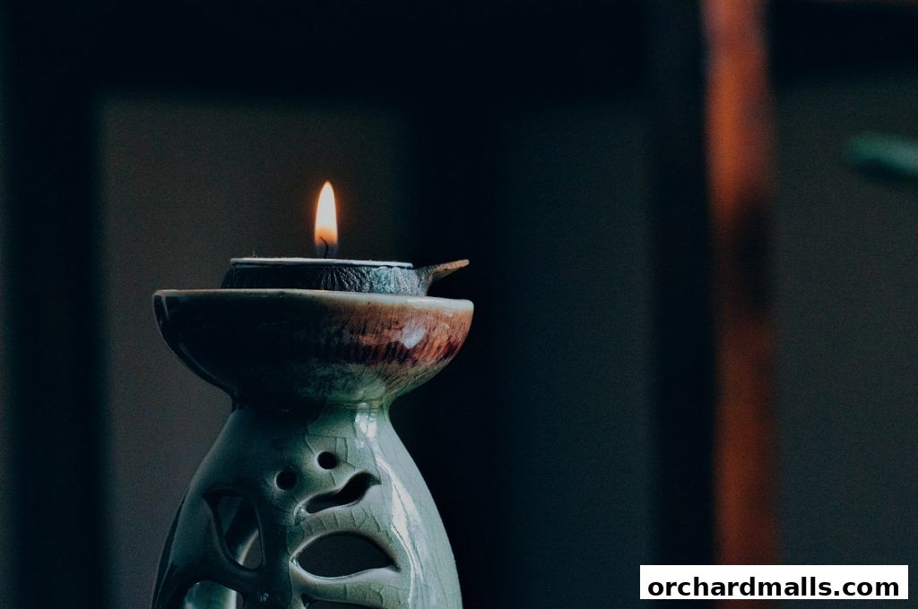 A lit candle in an ornate ceramic diffuser creates a serene ambiance.