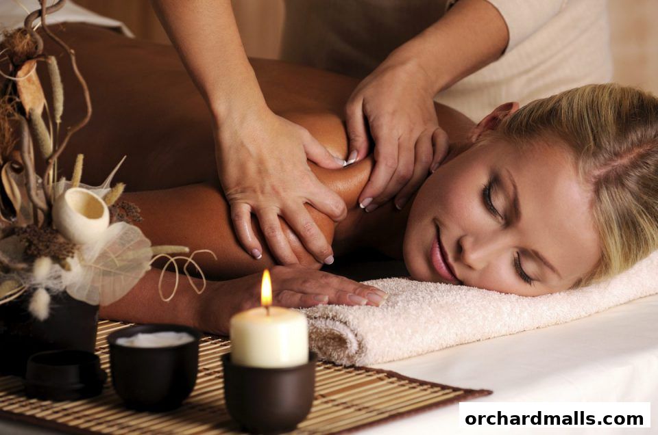 A woman receives a relaxing massage with a candle and decorative elements nearby.
