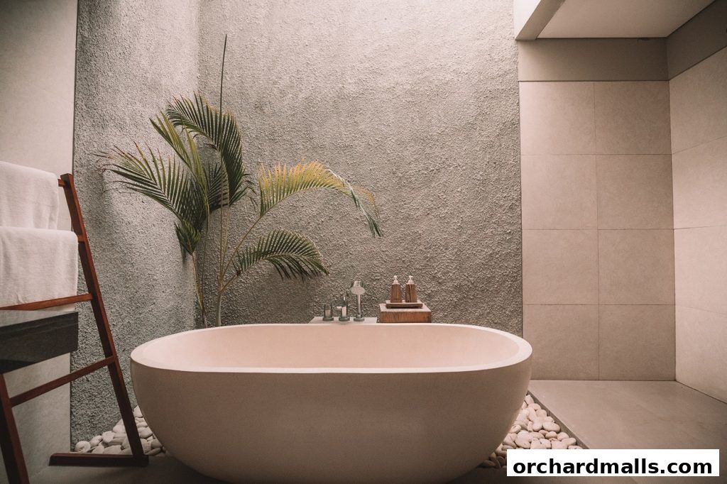 A modern bathroom with a freestanding bathtub, plant, and towels.