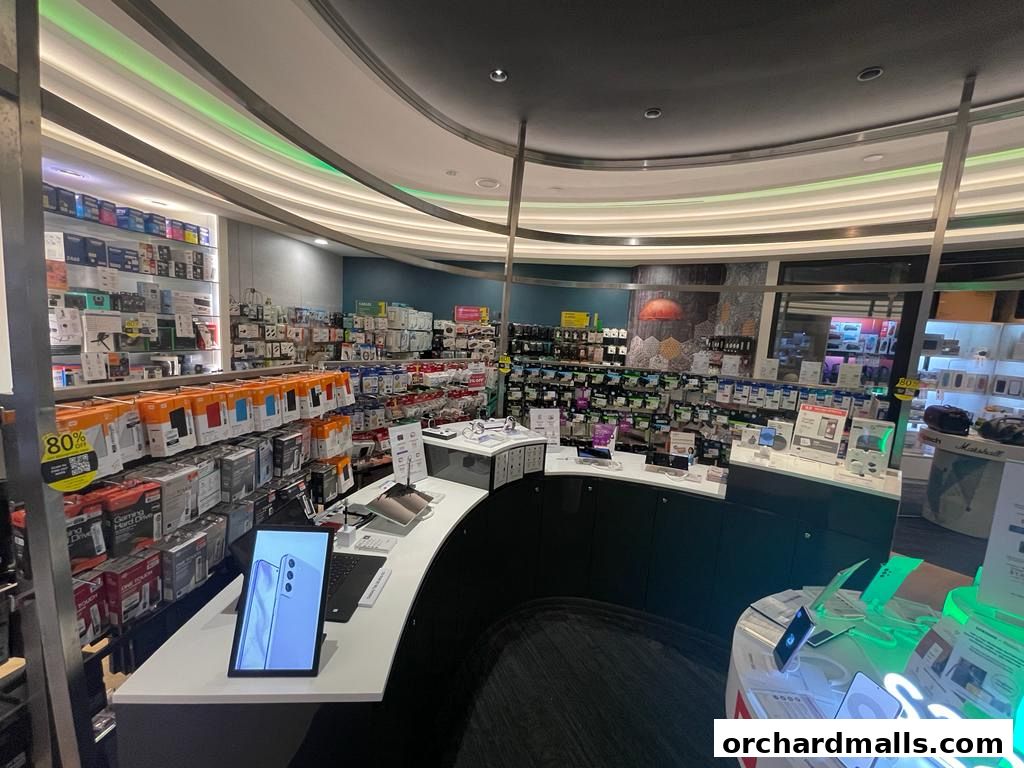 Interior view of a well-stocked electronics store with various gadgets and accessories on display.