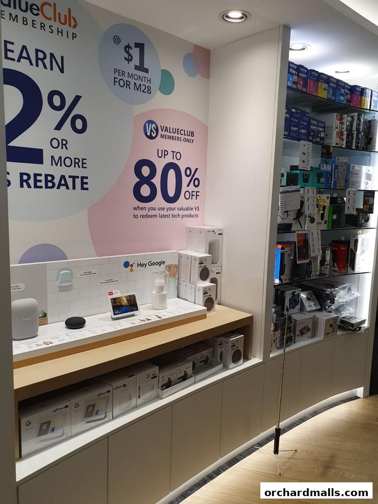 A retail store display featuring Google smart home devices and promotional signage for a membership program.