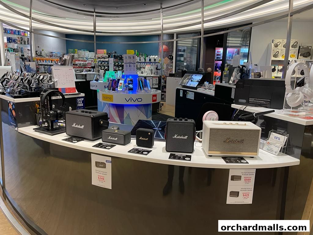 A display of Marshall speakers and headphones in a retail electronics store.