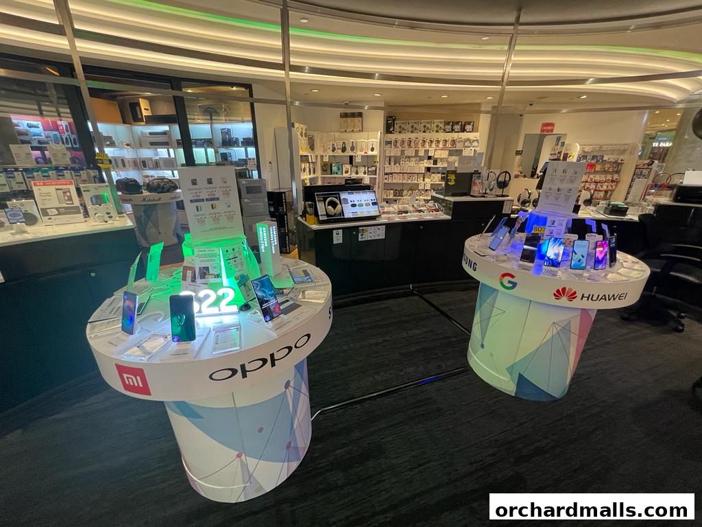 Interior shot of a Challenger store showcasing mobile phones and accessories on display stands.