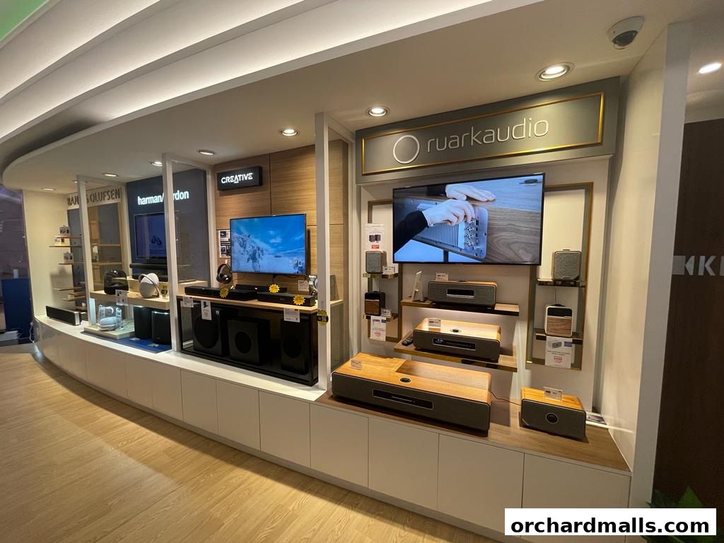 A retail display showcasing various audio equipment from brands like Ruark Audio and Harman Kardon.