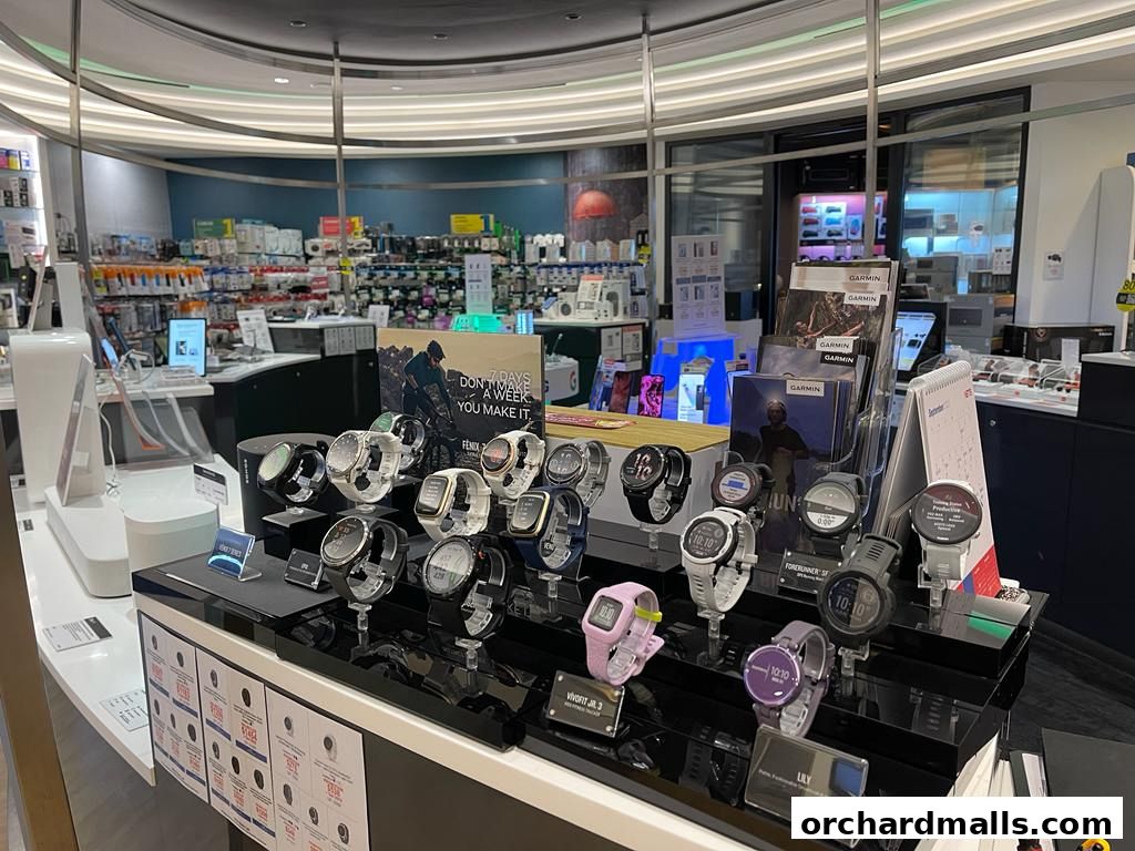 A display of various Garmin smartwatches and accessories in a retail store.