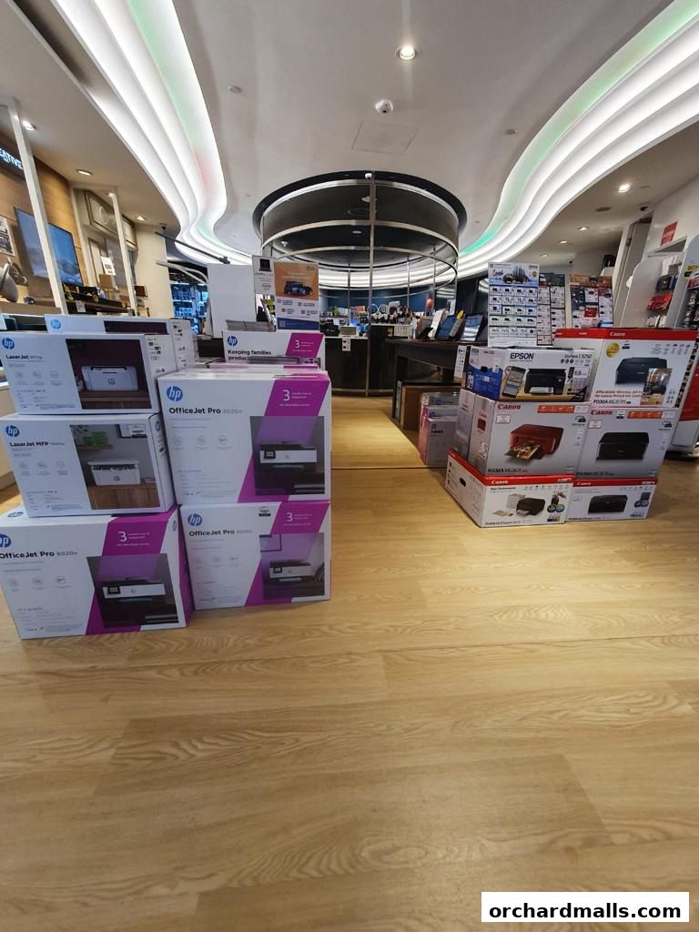 Interior view of a Challenger store showcasing various HP and Canon printers on display.