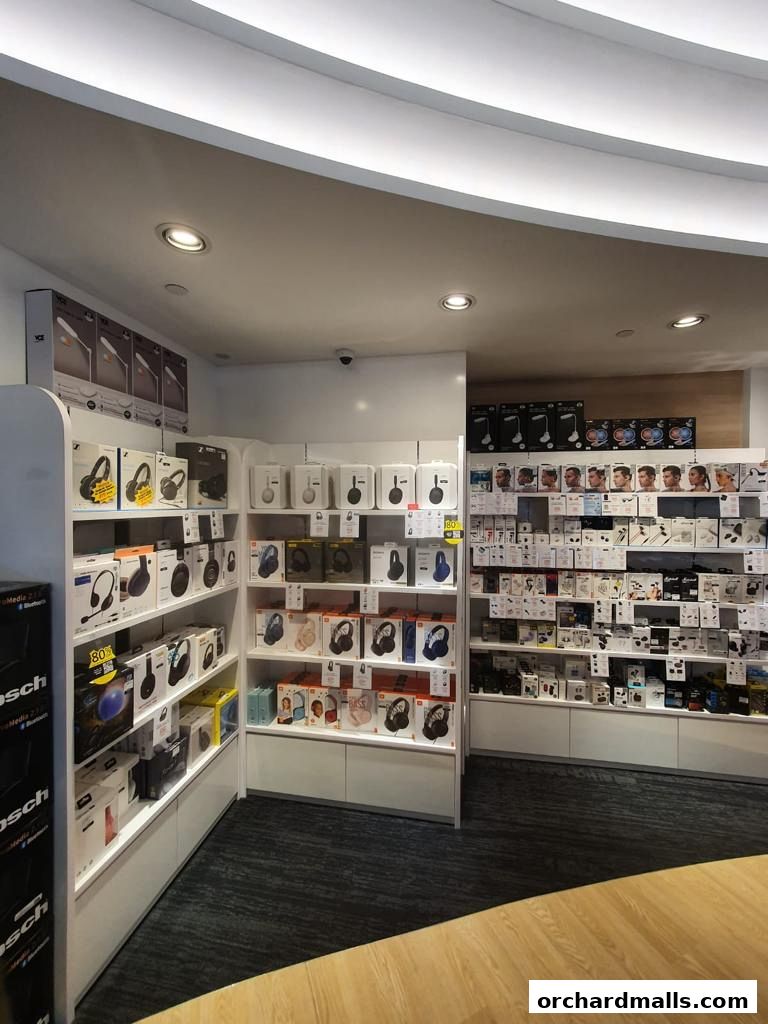 Interior view of a retail store showcasing a wide selection of headphones and audio accessories on display shelves.