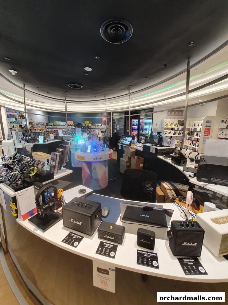 Interior view of a Challenger store showcasing various electronics, including Marshall speakers and Vivo phones.