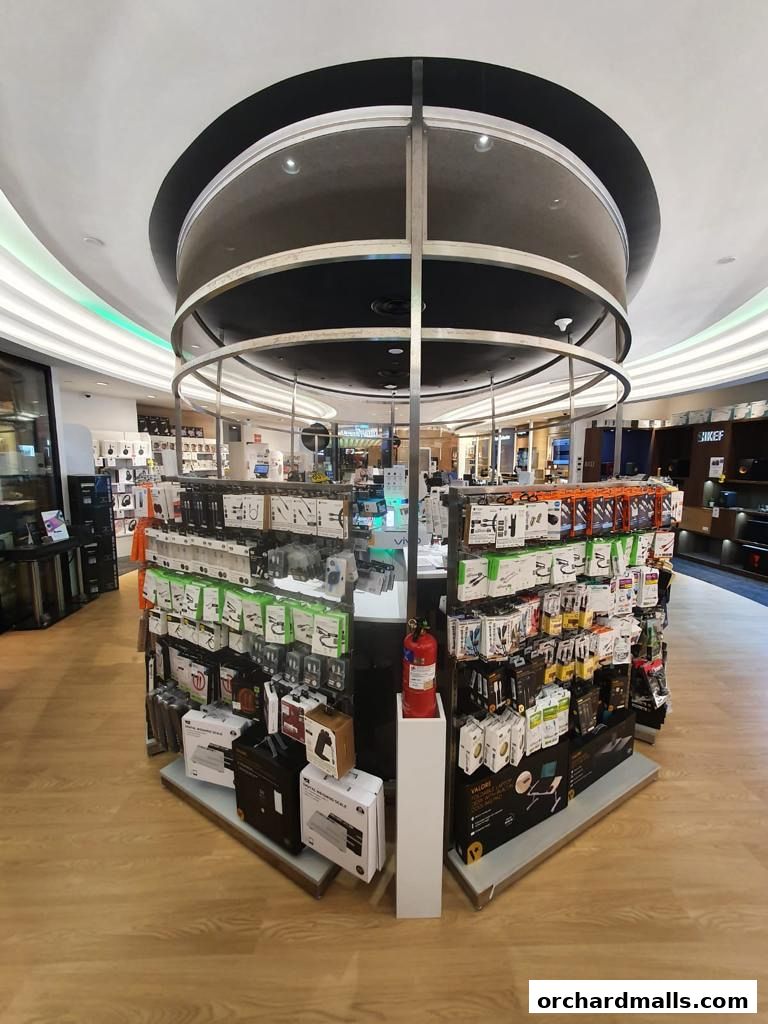 Interior view of a retail store displaying various electronic accessories and gadgets on display stands.